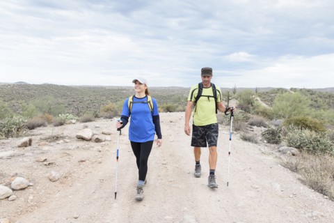 Couple hiking on rocky path in desert