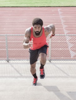 African American man running on bleachers