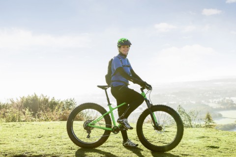 Portrait of smiling Caucasian woman riding bicycle