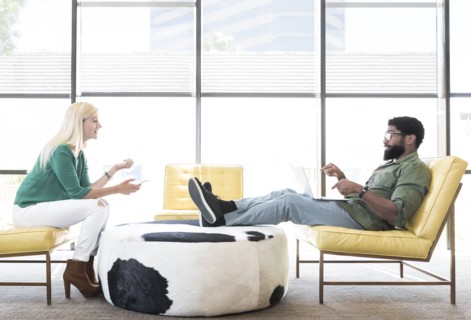 Friends using technology in lounge