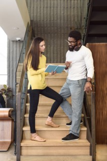 Creative business people talking on staircase