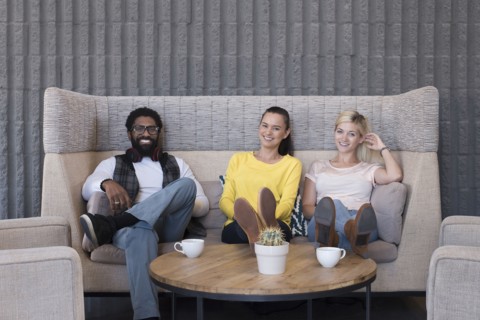 Portrait of smiling friends in lounge
