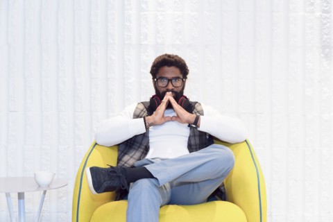 Pensive black man sitting in yellow chair