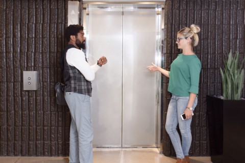 Man and woman waiting for elevator