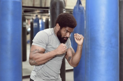 Black man using punching bag