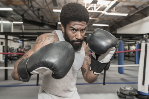 Black man posing in boxing ring