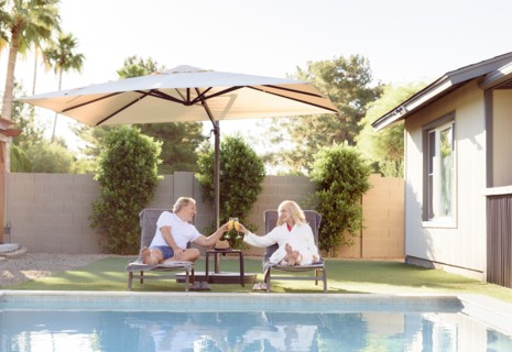 Caucasian couple toasting near swimming pool