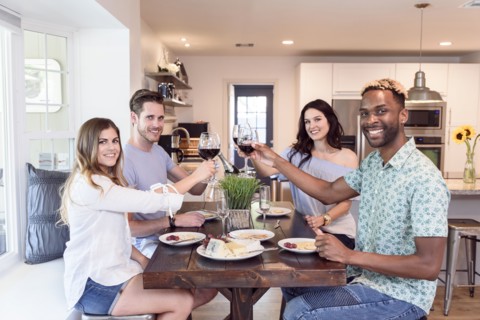 Portrait of friends toasting with red wine