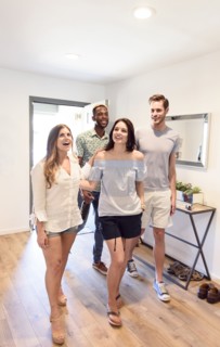 Smiling couples walking indoors