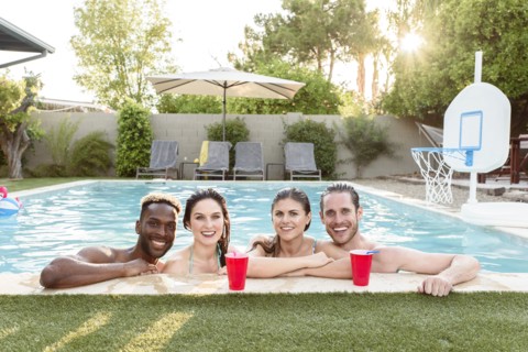 Portrait of smiling friends in swimming pool