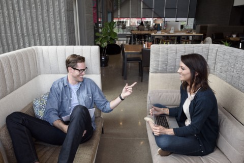 Caucasian couple sitting on sofas talking