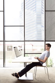 Pensive Caucasian man staring at computer