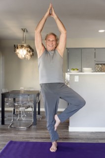 Caucasian man practicing yoga in home