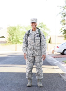 Portrait of black woman soldier standing in street