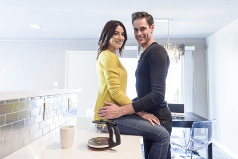 Portrait of Caucasian couple embracing on kitchen counter