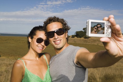 Couple taking self-portrait with camera