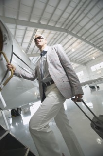 Middle-aged man boarding airplane in hanger