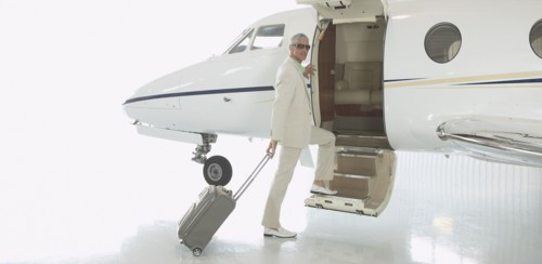 Middle-aged man boarding airplane in hanger
