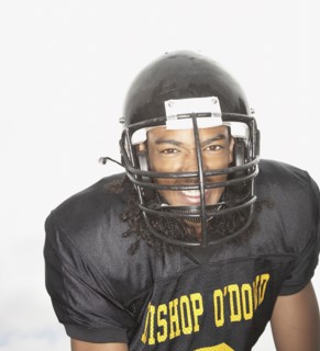 Young African man wearing football uniform