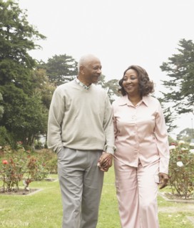 Senior African couple holding hands and walking outdoors