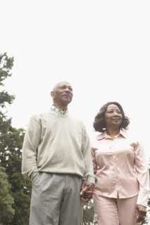 Senior African couple holding hands outdoors