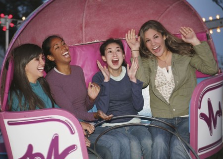Multi-ethnic girls on amusement park ride