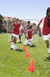 Multi-ethnic children playing soccer