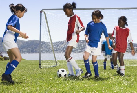Multi-ethnic children playing soccer