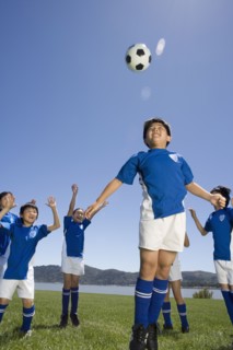 Multi-ethnic children playing soccer