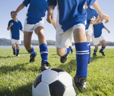Asian children playing soccer