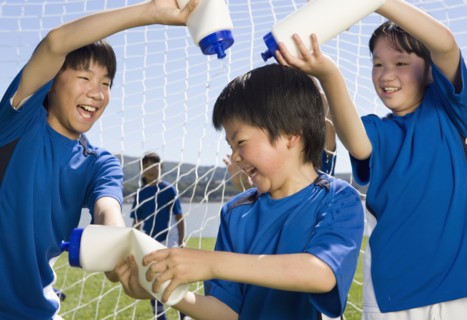 Asian boys playing with water bottles