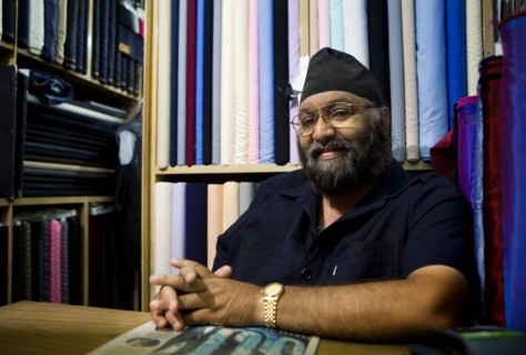 Indian business owner sitting in fabric store