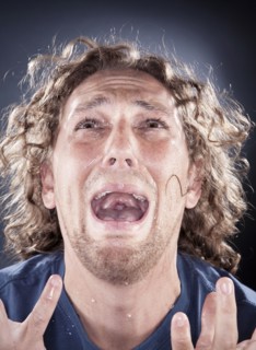Caucasian man looking up and shouting