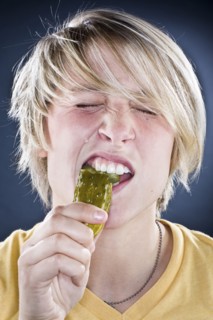 Caucasian boy eating pickle