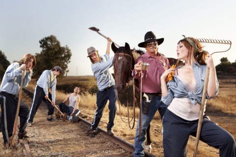 Sheriff  watching criminals working on chain gang