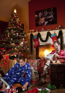 Caucasian father and son in living room on Christmas morning