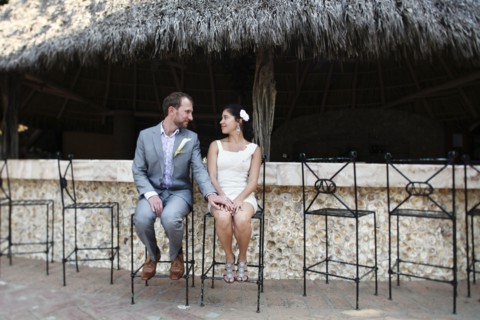 Newlywed couple sitting on bar stools