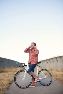 Bicycle messenger stopping on urban path