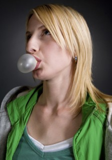 Caucasian woman blowing bubble with bubble gum