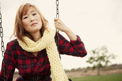 Korean woman sitting on a swing