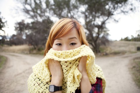 Korean woman covering  her face with scarf
