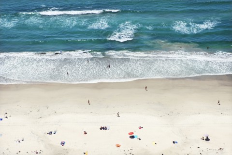 People relaxing on sunny beach