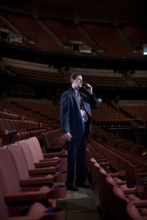 Businessman using walkie-talkie in empty auditorium