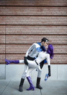 Couple in superhero costumes kissing