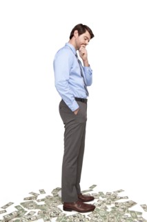 Caucasian businessman standing on money