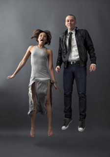 Couple jumping together in studio