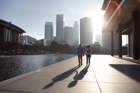 Couple casting shadows on urban waterfront