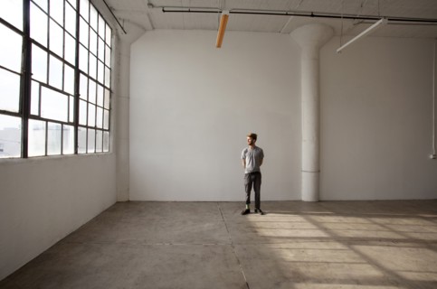 Caucasian man standing in empty loft
