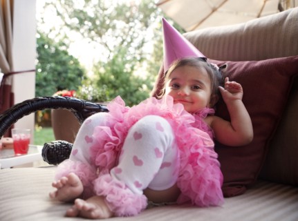 Smiling mixed girl wearing party hat