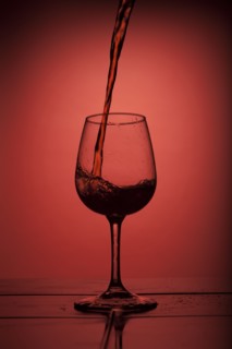 Red wine pouring into wine glass